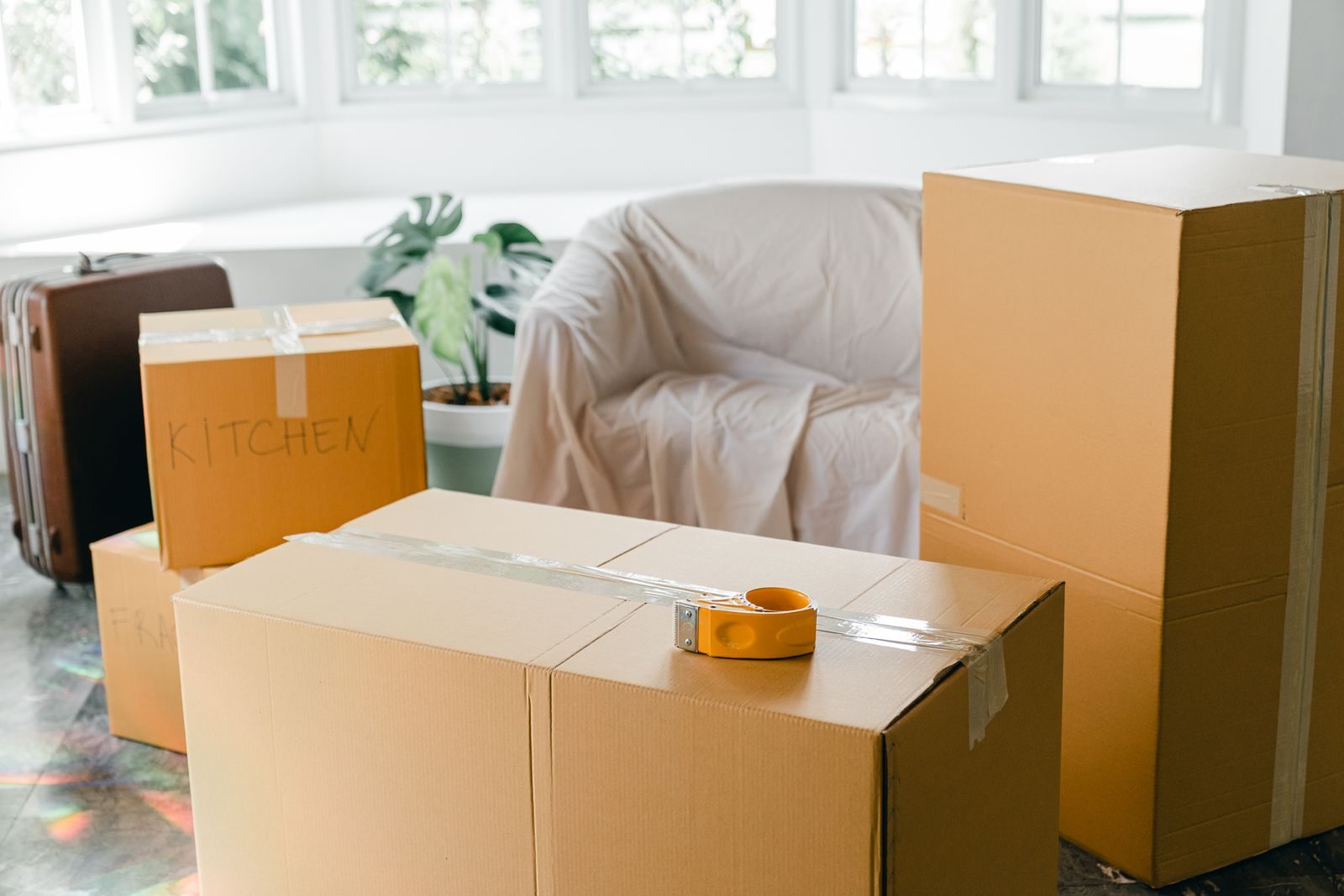 Bright empty apartment with packed moving boxes
